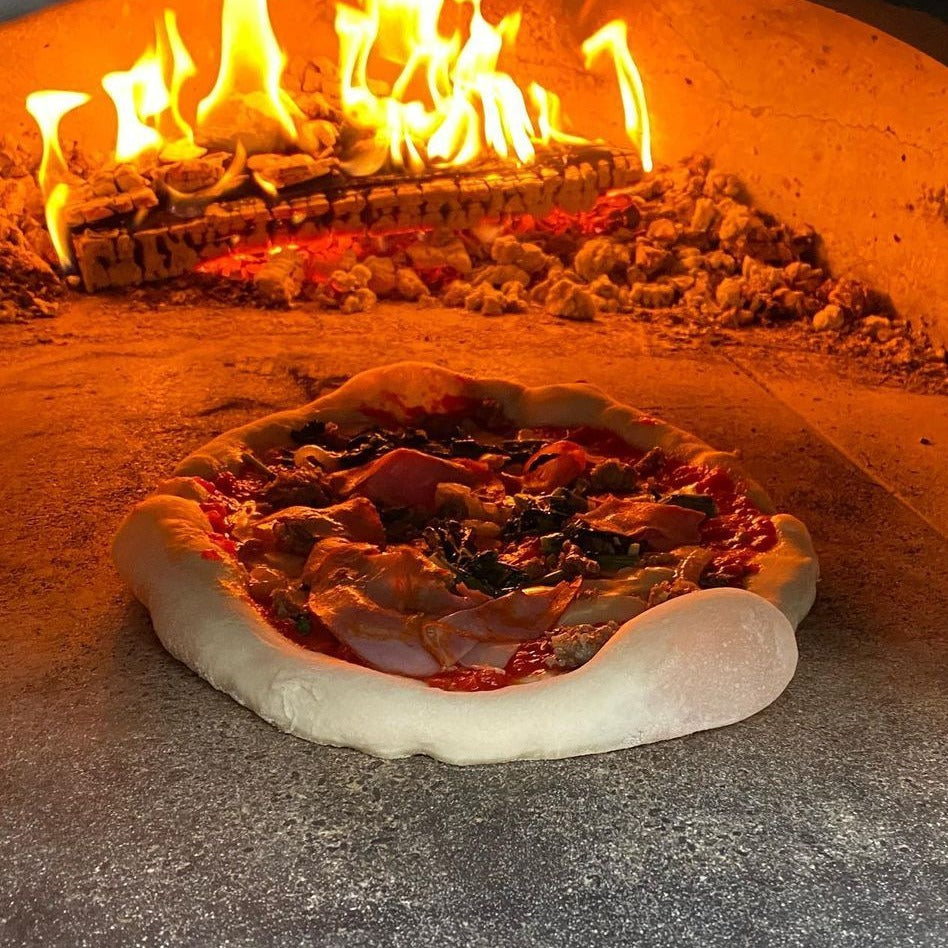 Inside view of CBO-750 tailgater pizza oven with pizza inside