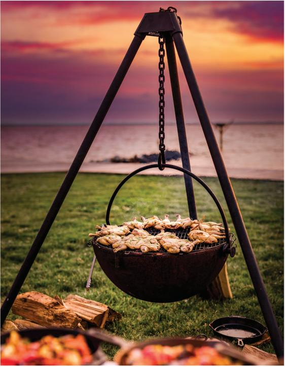 Tripod stand Wood Burning Fit Pit at ocean side, A chain Suspension Holding the Wood Burning Fire Pit with chickens on the top. BACKYARD SOPHISTICATION, IN A MODULAR FLOATING FIRE PIT PIECE DESIGNED TO BE FUNCTIONAL AND ARTISTIC
The cowboy Cauldron Wrangler is a Modular Floating Firepit that with not only heat up the night, but wow your guests with its beauty and craftsmanship.
Made Right here in the USA the Cowboy Cauldron is a one of a kind outdoor patio feature, that is easily moved to be anywher