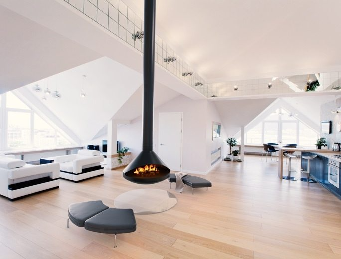 36" Modern Suspended/Floating Single Sided Black Vita Aidan Fireplace in a Large white painted living room with Fireplace in the middle. Water Vapor-Fire technology and Wood burning UFO design Fireplace. This Mid-century design hanging fireplace offers efficient heating, easy installation, and elegance. Aidan suspended fireplace is similar to Focus Ergofocus Holographic Suspended Electric Fireplace, Focus GYROFOCUS Fireplace, Shine 1 Luxury Hanging Disc-Shaped Real Wood Burning Fire Fireplace.