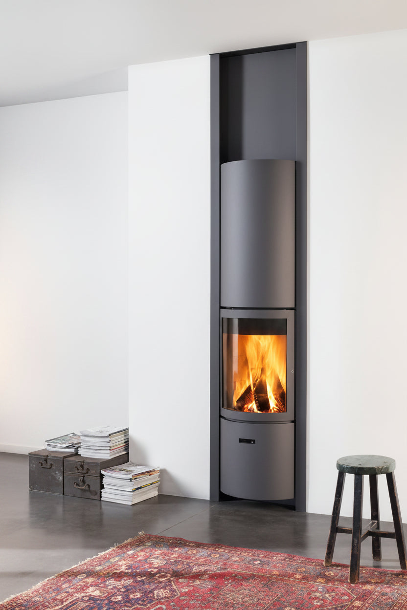 Modern freestanding fireplace with visible flames in a minimalistic room. MCM Fireplace hand built wood freestanding stove Modern room with large windows, wooden floor, and a freestanding stove. Modern cabin Modern fireplace with a basket of wood on a red and gray wall STUV Modern MCM Fireplace Cylinder fireplace Modern floating fireplace with steel plate for low clearance zero clearance fireplace background Flue Pipe Dura-vent