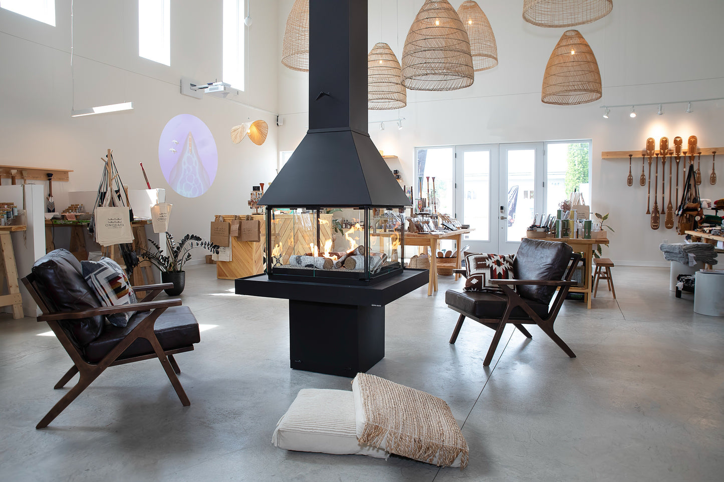 Modern living room with a Matte black Don bar 9200 series fireplace with chairs, and decorative elements.