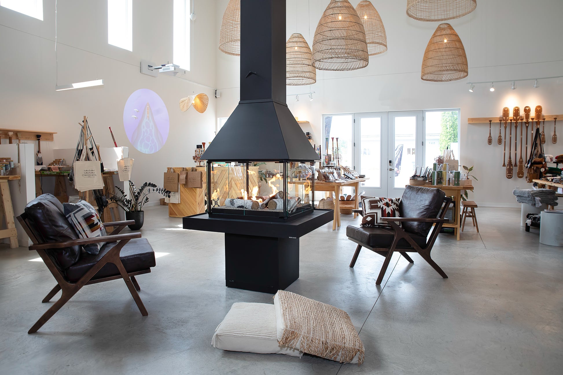Modern living room with a Matte black Don bar 9200 series fireplace with chairs, and decorative elements.