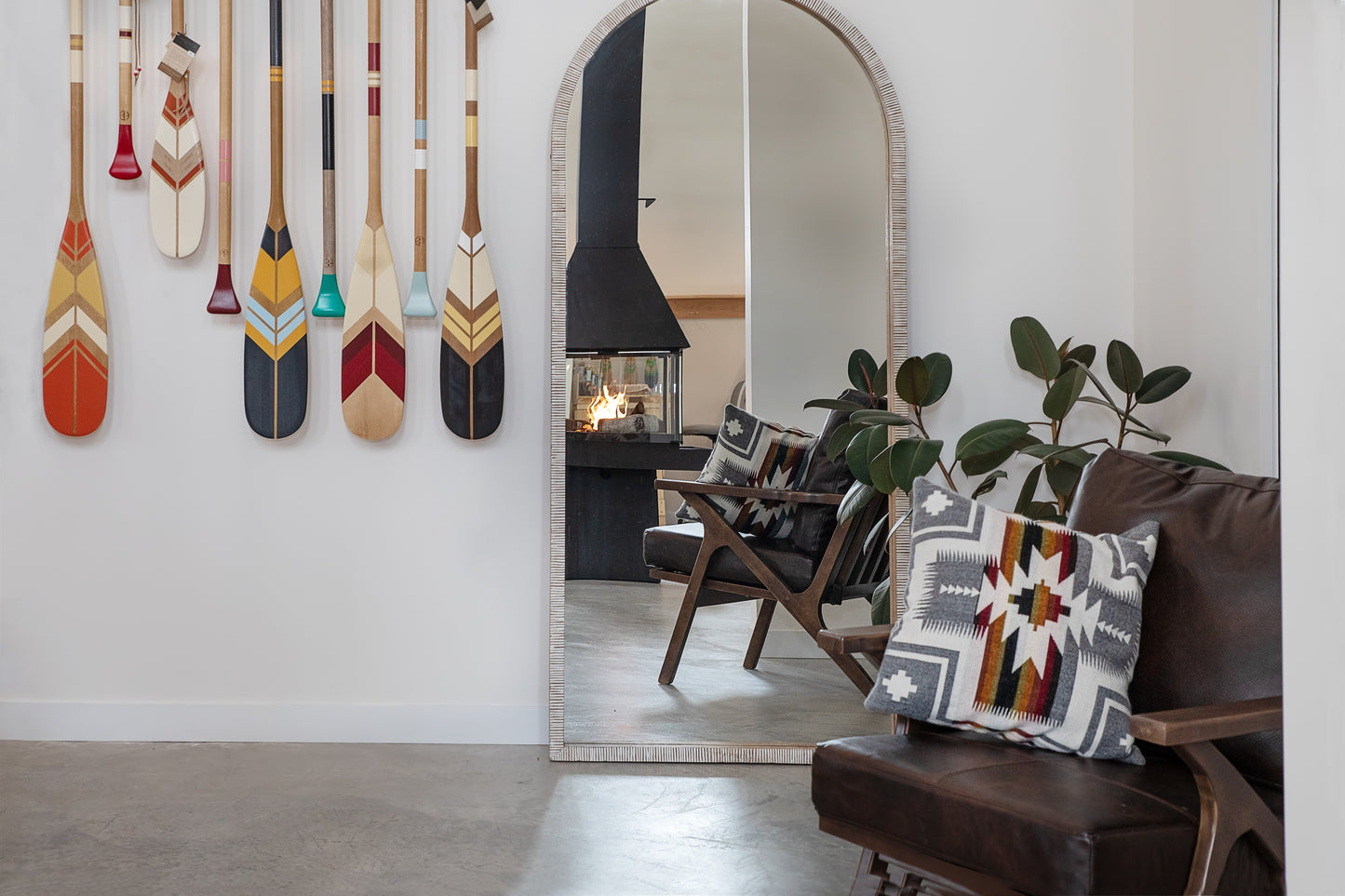 Matte Black Don Bar 9200 series in a Living room with decorative pillows, a mirror, and wall-mounted paddles.
