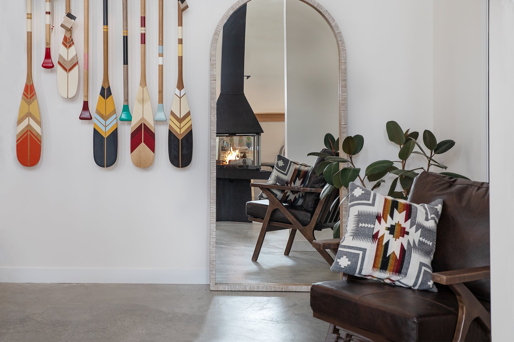 Matte Black Don Bar 9200 series in a Living room with decorative pillows, a mirror, and wall-mounted paddles.