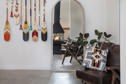 Matte Black Don Bar 9200 series in a Living room with decorative pillows, a mirror, and wall-mounted paddles.