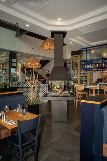 Matte Black Don bar 9200 series in a Modern restaurant interior with a kitchen island and dining tables.