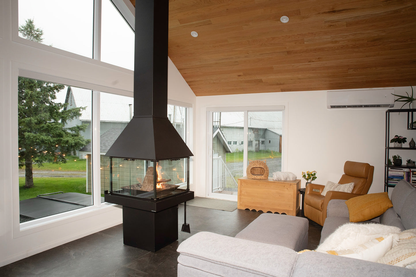 Modern living room with a Matte Black Don Bar 9200 series fireplace and large windows