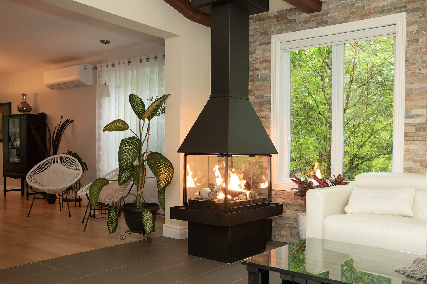 Matte Black Don bar 9200 series in a Modern living room with a black Chimney connected to the ceiling and a view of trees outside.