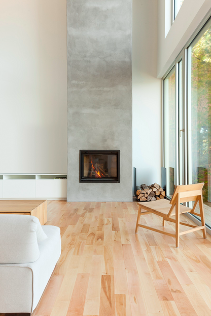 Valcourt Antoinette Black Built-in indoor wood burning fireplace with mansory trim, guillotine-style door and  visible wood burning flame in a modern living room with large window. Heating area up to 1,000 sq. ft, EPA qualified. Antoinette Modern hearth fireplace is similar to Majestic Biltmore Wood Burning Fireplace - 50", Supreme Astra Single-Sided Wood Burning Fireplace, Empire Aspen Traditional Wood Burning Fireplace, Montigo Divine Bay H38DFPRC Direct Vent Gas Fireplace, Modern Flames Orion.