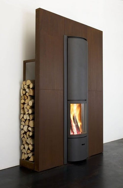 Modern fireplace with a basket of wood on a red and gray wall STUV Modern MCM Fireplace Cylinder fireplace Modern floating fireplace with steel plate for low clearance zero clearance fireplace background Modern wood-burning stove with firewood storage on a white background