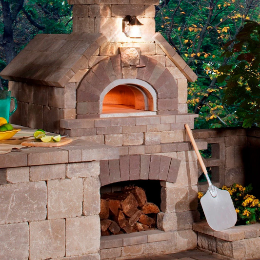 Brick outdoor Wood-fired pizza oven DIY KIT with wood storage on a patio outdoor kitchen setup ready to make your perfect outdoor kitchen. CBO 1000 wood fired Pizza Oven, natural gas pizza oven, DIY pizza oven kit, residential countertop pizza oven, Chicago Brick Oven, backyard pizza oven, outdoor kitchen pizza oven, hybrid pizza oven for home. Alfa Pizza Oven 3 pizze but better made in America, Wood Burning oven -Ooni Gozney.
