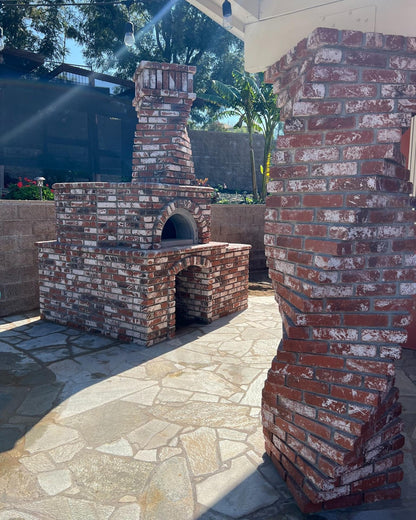 Brick outdoor Wood-fired pizza oven DIY KIT with wood storage on a patio outdoor kitchen setup ready to make your perfect outdoor kitchen. CBO 1000 wood fired Pizza Oven, natural gas pizza oven, DIY pizza oven kit, residential countertop pizza oven, Chicago Brick Oven, backyard pizza oven, outdoor kitchen pizza oven, hybrid pizza oven for home. Alfa Pizza Oven 3 pizze but better made in America, Wood Burning oven -Ooni Gozney.