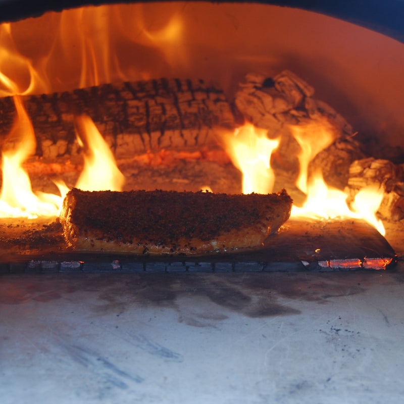 Brick outdoor Wood-fired pizza oven DIY KIT with wood storage on a patio outdoor kitchen setup ready to make your perfect outdoor kitchen. CBO 1000 wood fired Pizza Oven, natural gas pizza oven, DIY pizza oven kit, residential countertop pizza oven, Chicago Brick Oven, backyard pizza oven, outdoor kitchen pizza oven, hybrid pizza oven for home. Alfa Pizza Oven 3 pizze but better made in America, Wood Burning oven -Ooni Gozney.