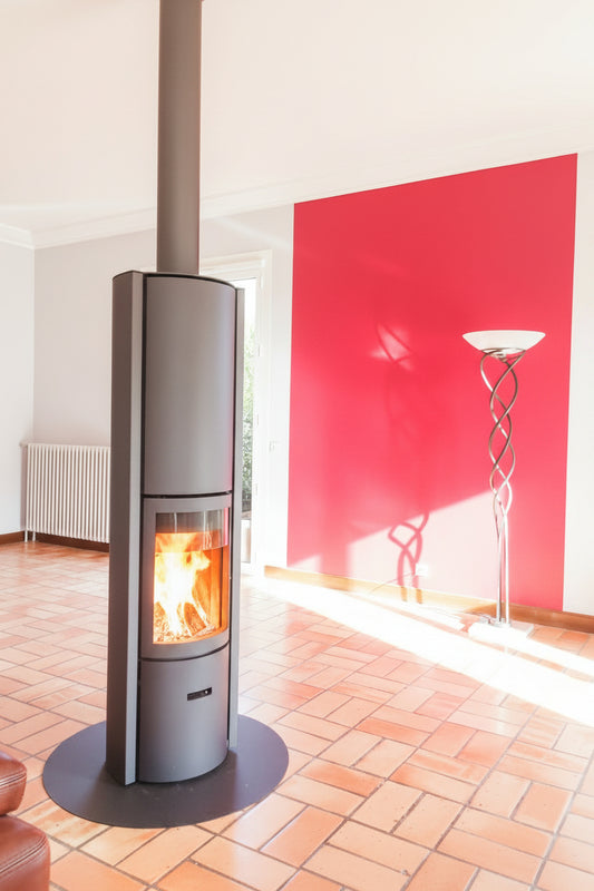 Modern fireplace with a basket of wood on a red and gray wall STUV Modern MCM Fireplace Cylinder fireplace Modern floating fireplace with steel plate for low clearance zero clearance fireplace background