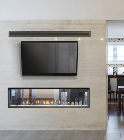 Montigo Distinction Linear Gas Fireplace Inserts into a Wall that connects the modern living room with Dinning room with wall mounted television above the fireplace. Indoor Eco-friendly direct vent fireplace suitable for homes and commercial space.