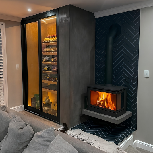 Black finish wood burning stove Dorako sto M 14 Right corner fireplace on a marble table top with a burning fire view in a modern living room beside a wine cooler.
Cast iron freestanding Wood burning close combustion fireplace.
Dorako sto M 14 R is similar to Montigo DIVINE Multi Corner Gas Fireplace | H38CL/CR, Dorako ECO Max 7 Left /Right Corner Wood Burning Fireplace - Scandinavian Modern Wall-Insert Stove - Right hand Corner / Standard.
