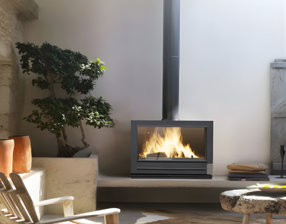 Invicta Aaron Double Sided Glass 36" Cast Iron Wood burning Stove with flame inside in a living room.