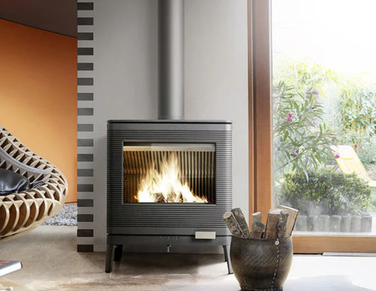 Modern fireplace with flames in a room with a window and decorative MCM Sleek Danish design modern fireplace with sleek elements. This Danish Style Hygge fireplace is handmade in France