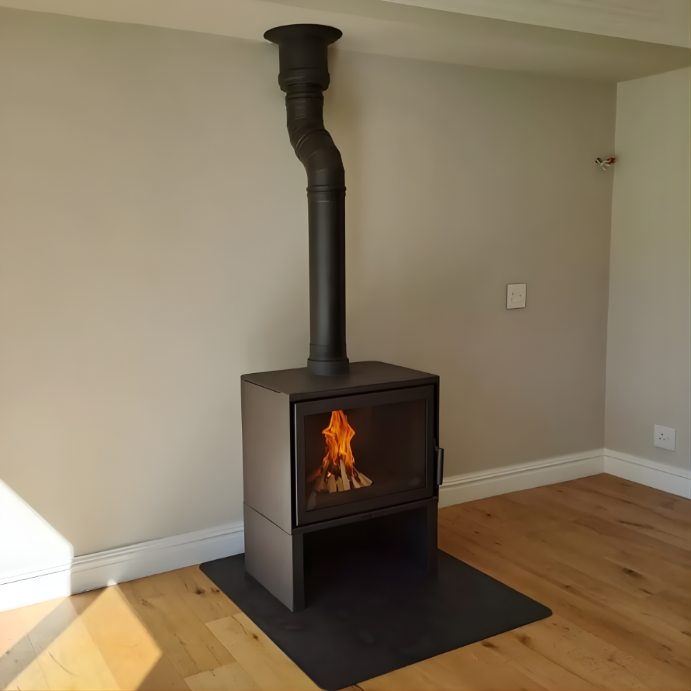 Scandinavian Style Black Dorako STO M14 Wood-burning stove with a chimney with Visible flame in a room with wooden flooring and beige walls. 100,000 BTUs with A+ energy efficiency class KFC STUV CUBE 16H  Square Box Style Fireplace by KFD similar to JOTUL STUV DON BAR