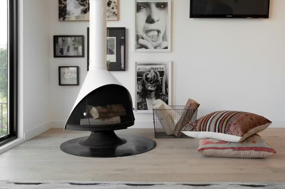 White Coated Top Finish and a Matte Black Base Finish Cone shape Malm 30" zircon wood burning fireplace in a Modern living room with wall art hanging and decorative pillows.