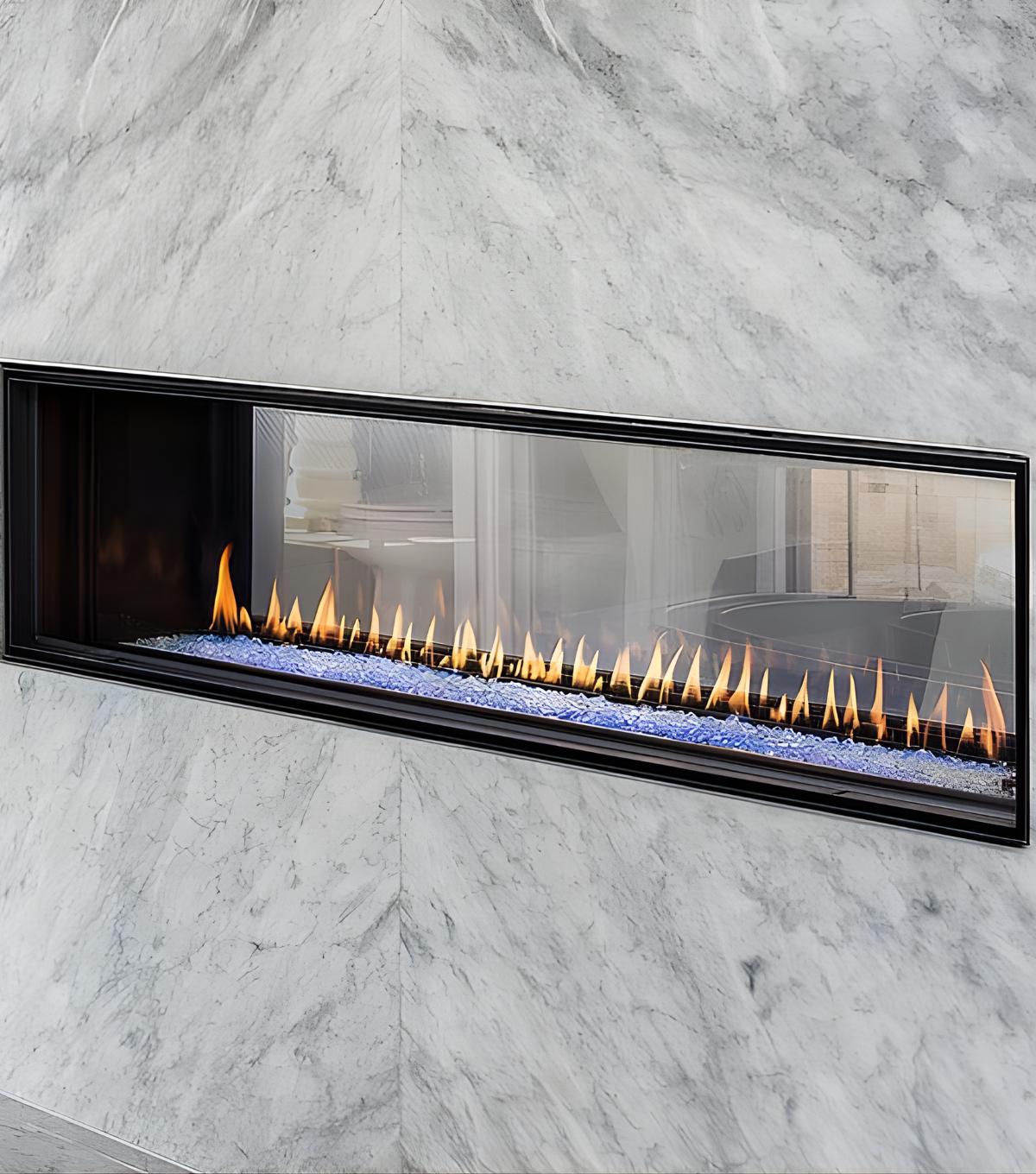 Close View of Montigo Distinction See through Built-In Linear Gas Fireplace with a visible flame in a Marble Wall. Double Sided Eco-friendly Indoor Gas Fireplace suitable for Home and commercial space.