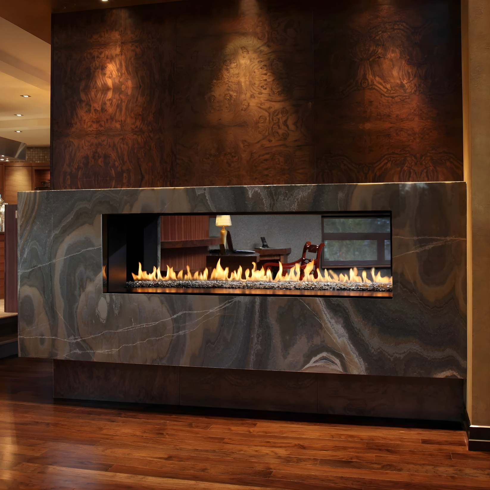 Gas burning double sided Montigo Exemplar Indoor gas Fireplace Inserts into a marble like wall with a visible burning flame in a modern living room with fireplace connecting living room with dinning.
Create a modern look with one of our many exquisite Built-In See through gas fireplaces. This Eco-friendly Montigo Exemplar is similar to 48" Isokern Maximus Linear Gas Fireplace, Napoleon Clearion Elite See-Through Fireplace, Empire 48" Boulevard Direct Vent See-Through Linear Gas Fireplace, Dimplex IgniteXL.