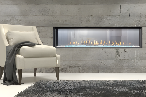 Luxury See through Double Sided Gas Fireplace Inserts in a well lighted modern Living room with white Couch. Built-In Linear Direct Vent Fireplace with visible flames to Uplift your your residence and commercial space.