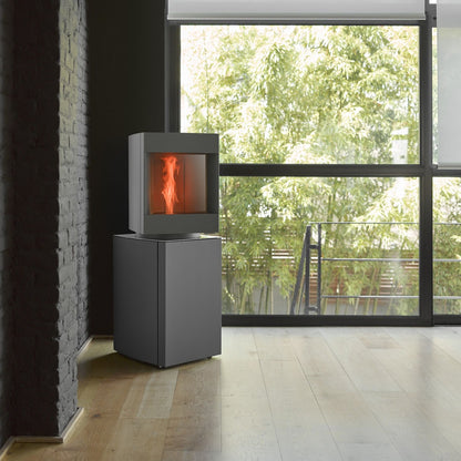 45 degree pivot head of Dark oak Base free standing Stuv S-P10 pellet stove with visible burning flame in a modern living room. Modern Indoor remote control and Smart phone control Home heating fireplace. Eco-Friendly, Gentle flame Indoor fireplace. This Fireplace is similar to ComfortBilt Alpine HP40 Pellet Stove, Osburn Volta Pellet Stove, Quadra-Fire Outfitter II Pellet Stove Display Demo,US Stove 1300 Sq ft Wood Pellet Stove, Castle | Serenity Pellet Stove.