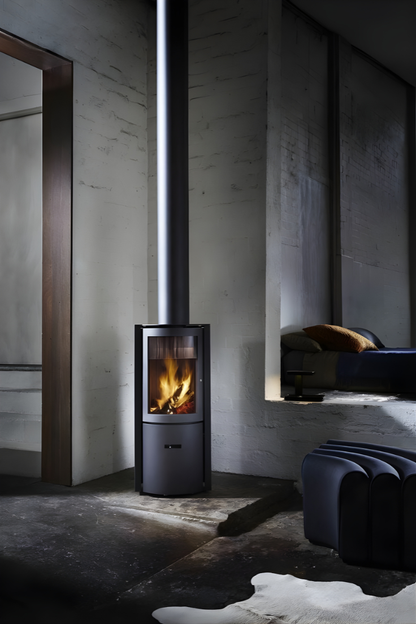 Freestanding Black Stuv 30C wood burning stove in a  dimly lit room with concrete walls and a rug.
