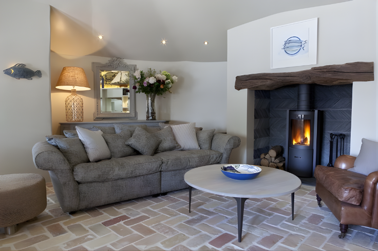 Living room with a fireplace, sofa, and coffee table. Alcove Stove Round modern rotating wood stove
360 degree fireplace
eco-friendly wood stove
high efficiency fireplace
clean burning wood stove
European design fireplace
contemporary wood-burning stove
STUV 30 fireplace  wood stove dealer Modern fireplaces in Bend Oregon Central and Southern Oregon Eastern Oregon Idaho Washington Northern California Nevada Utah luxury fireplace design
statement fireplace for living room
energy efficient heating solutions
