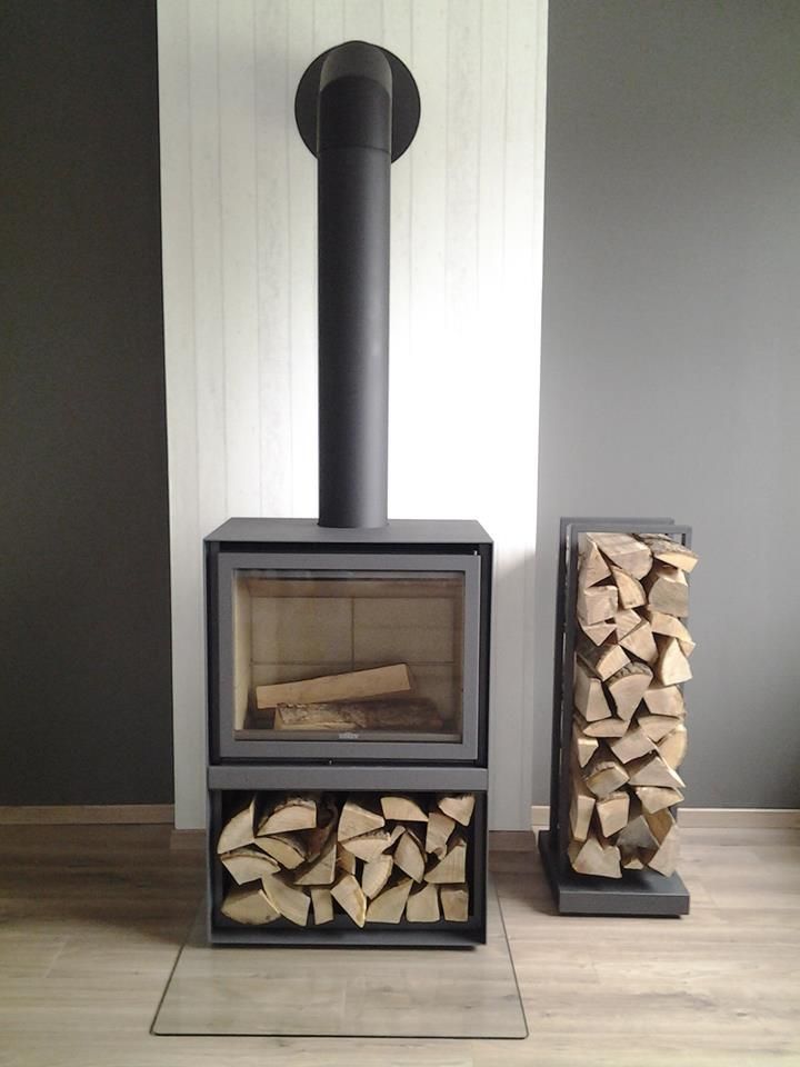 Black Stuv 16-H model wood burning stove with stacked logs