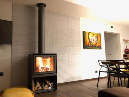 Grey Stuv 16-H model wood burning stove with burning woods