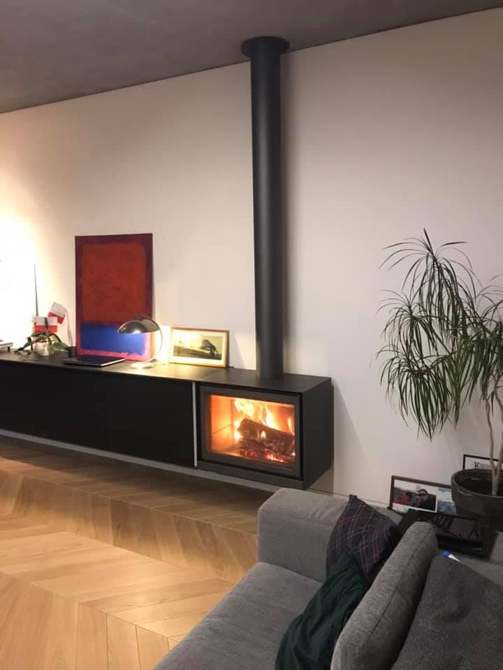 Living room installed Black Stuv 16-58 cube with Burning wood