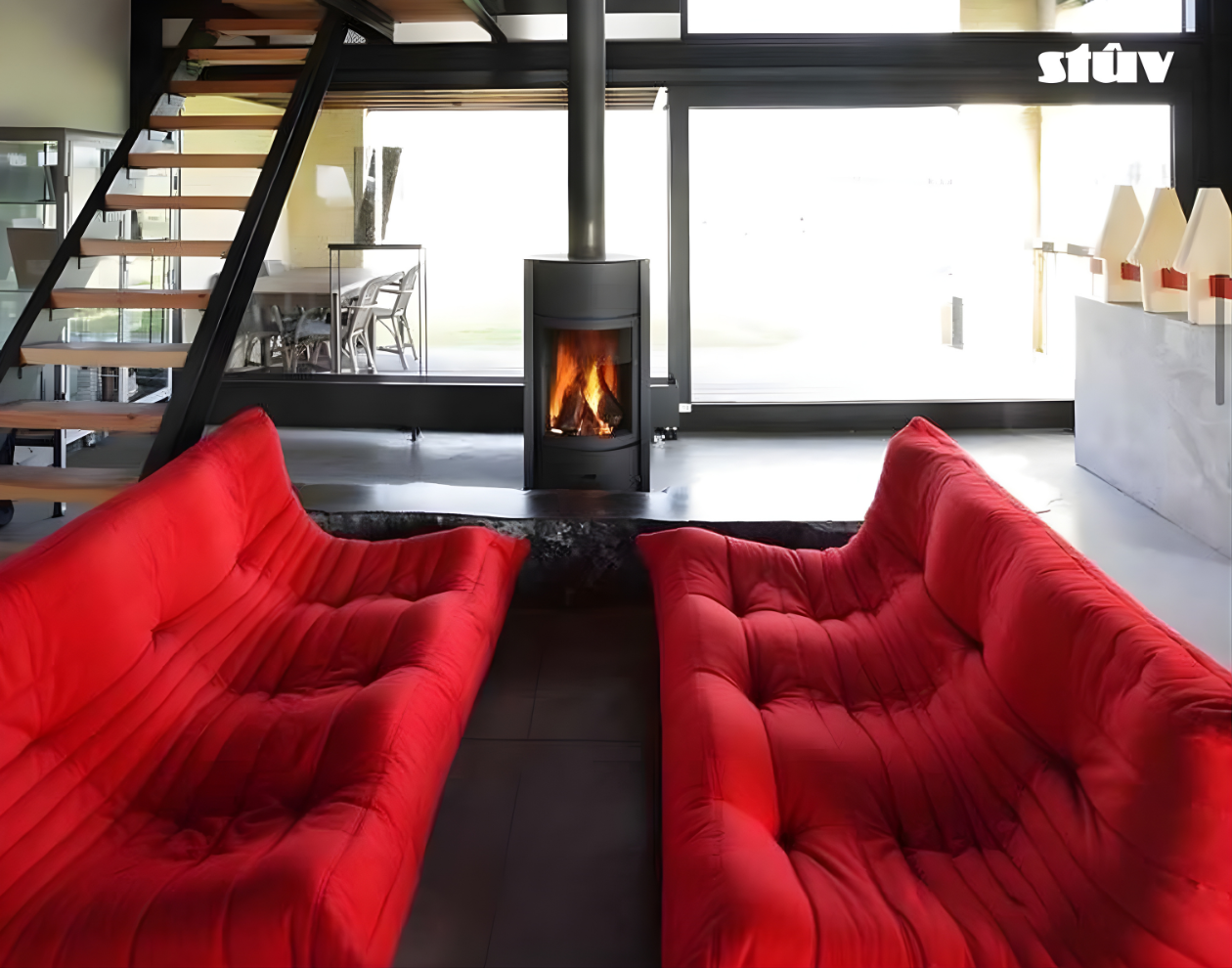 Grey Stuv 30C Freestanding highly efficient 360 degree rotating Modern wood burning stove with visible flame in a Modern living room with red sofas.
Premium and compact Indoor log burner fireplace with high-quality steel construction, Multi-Use Function and wide range BTU heat Output. 
Reduce your carbon footprint with Stuv 30C wood stove from Smokey Mountain Fireplace, Eco-friendly and Best for the money fireplace.