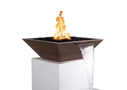 A square-shaped copper fire and water bowl is perched atop a white pedestal. The bowl features a sleek, contemporary design with clean lines and a dark, rustic copper finish. A vibrant fire burns at the center of the bowl, while a smooth stream of water cascades gracefully from one side of the bowl, creating a serene and luxurious focal point