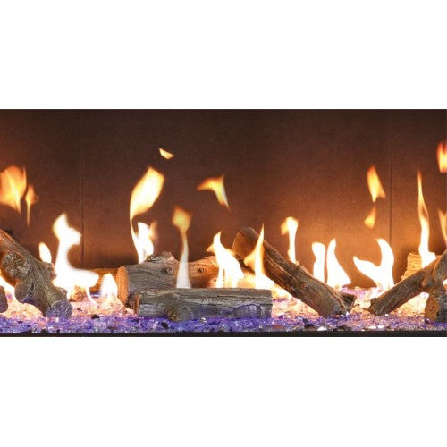 Up close view of Traditional log Gas Glass Fireplace with flames burning in a dark setting