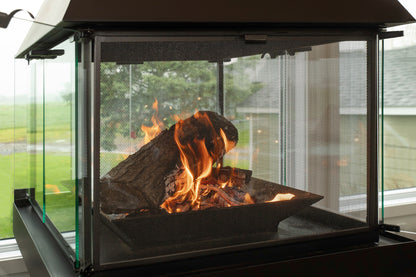 Don bar  fireplace with burning logs and flames, surrounded by glass panels.Matte Black Gas Burning Don bar 9200 series Fireplace in a Modern living room with white sofa, and large windows. all glass custom designed see through round fireplace Malm Style Carousel Style Focus fireplace floating fireplace UFO style floating overing see through round all glass fish tank style fireplace For a high-end, architectural piece like the Don-Bar 9200 Series, your SEO strategy needs to target luxury homeowners and desi