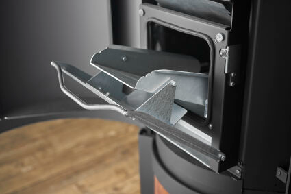 Hopper for loading pellets into Matte Black Stûv P-20S Freestanding Modern Indoor pellet burning stove in large close spade with visible burning flame and pellet twin set container beside the fireplace. Elegance,silence, performance, ease of use and maintenance Fireplace. This pellet stove is similar to Stûv 30 Wood Stove | Compact Glass Fire Screen Stove | 360° Adjustable Rotating Wood Burning Stove With Double Walls, Osburn Aduro H1 Pellet/Wood Combo Hybrid Free Standing Stove SF00401, Comfortbilt Pellet.