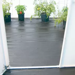  black polypropylene Greenhouse floor with a buckets of flowers on the floor