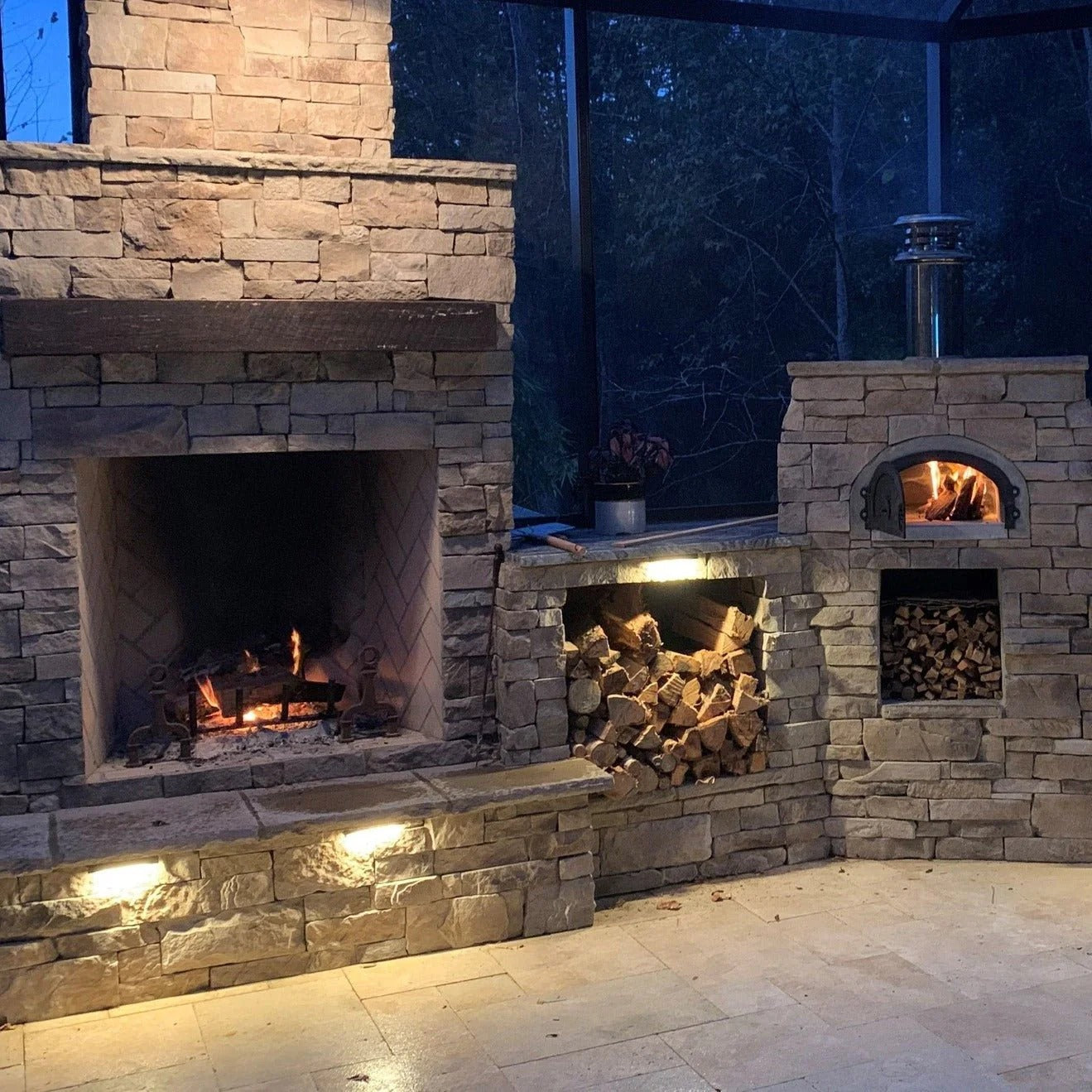 Brick outdoor Wood fired pizza oven with wood storage on a patio outdoor kitchen setup ready to make your perfect outdoor kitchen. CBO 750 Hybrid Pizza Oven, dual fuel pizza oven, outdoor wood fired pizza oven, natural gas pizza oven, DIY pizza oven kit, residential countertop pizza oven, Chicago Brick Oven, backyard pizza oven, outdoor kitchen pizza oven, hybrid pizza oven for home. Alfa Pizza Oven 3 pizze but better made in America  with built in Gas BBQ LPG NG Pizza Oven Wood Burning Ooni Gozney