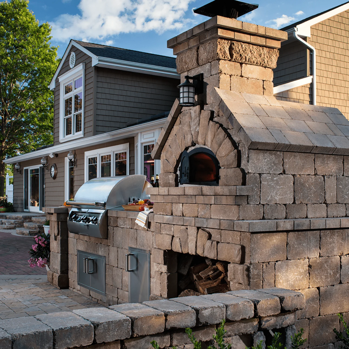 Brick outdoor Wood fired pizza oven with wood storage on a patio outdoor kitchen setup ready to make your perfect outdoor kitchen. CBO 750 Hybrid Pizza Oven, dual fuel pizza oven, outdoor wood fired pizza oven, natural gas pizza oven, DIY pizza oven kit, residential countertop pizza oven, Chicago Brick Oven, backyard pizza oven, outdoor kitchen pizza oven, hybrid pizza oven for home. Alfa Pizza Oven 3 pizze but better made in America  with built in Gas BBQ LPG NG Pizza Oven Wood Burning Ooni Gozney