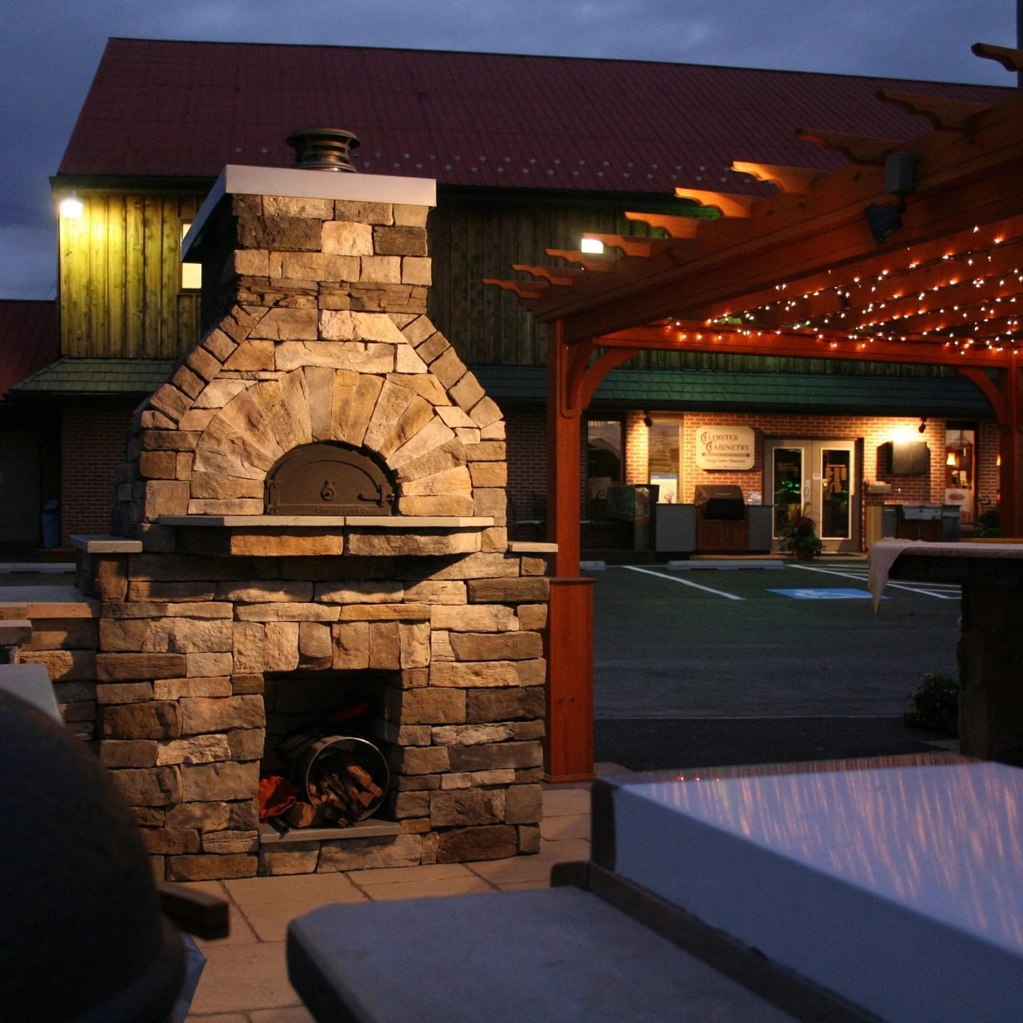 Brick outdoor Wood fired pizza oven with wood storage on a patio outdoor kitchen setup ready to make your perfect outdoor kitchen. CBO 750 Hybrid Pizza Oven, dual fuel pizza oven, outdoor wood fired pizza oven, natural gas pizza oven, DIY pizza oven kit, residential countertop pizza oven, Chicago Brick Oven, backyard pizza oven, outdoor kitchen pizza oven, hybrid pizza oven for home. Alfa Pizza Oven 3 pizze but better made in America  with built in Gas BBQ LPG NG Pizza Oven Wood Burning Ooni Gozney