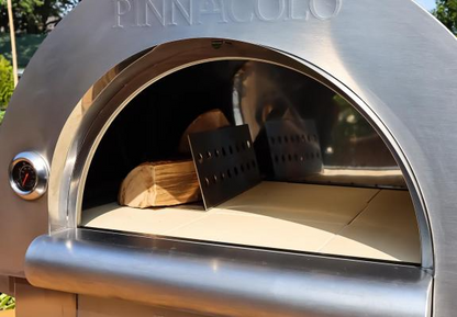 Pinnacolo Stainless steel pizza oven with wood and spatula inside