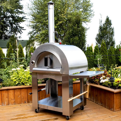 Pinnacolo PREMIO Wood-fired Stainless steel pizza oven on a wooden deck with greenery in the background