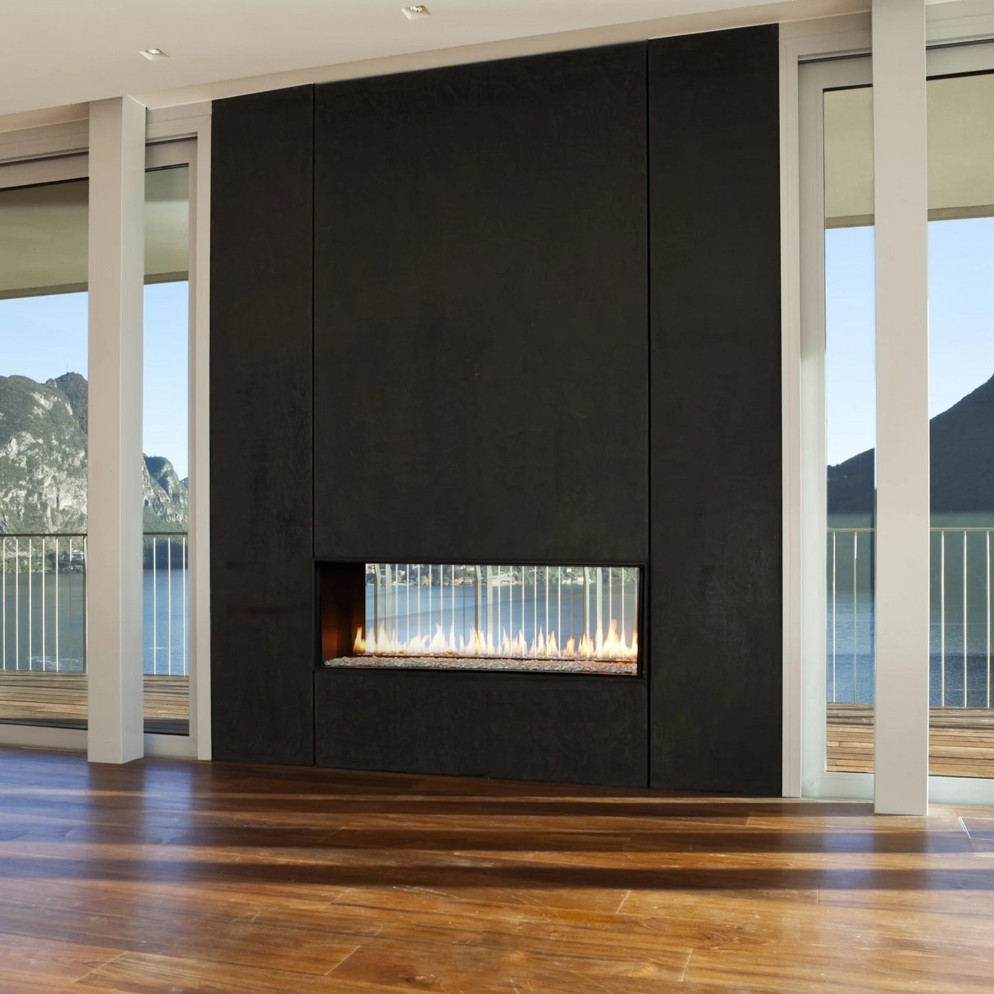 Elegant Montigo Exemplar Built-In See Through Linear Gas Fireplaces Inserts into a black Surrounds in a modern living room with wooden flooring and large windows. Eco-Friendly Modern indoor Gas Fireplace suitable for home and commercial spaces.
Create a modern look with one of our many exquisitegas fireplaces. This Eco-friendly Montigo Exemplar is similar to 48" Isokern Maximus Linear Gas Fireplace, Napoleon Clearion Elite See-Through Fireplace, Empire 48" Boulevard Direct Vent See-Through fireplace.