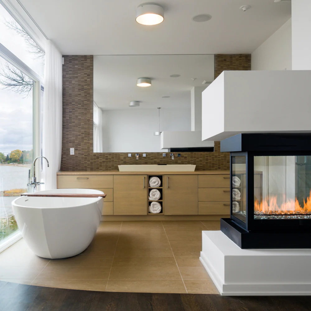 3 Sided 38" Divine Pier Direct vent Indoor Gas Fireplace Inserts into a wall in a modern bathroom with a visible flame. 
We offer premium multi-sided gas fireplaces.
This See through Modern Fireplace With its contemporary linear burner and captivating multi-sided design is similar to 3 Sided Glass Open View Wide Angle Glass Fireplace by KFD, Sierra Flame Toscana 48" Three Sided Gas Burning Fireplace, Heat & Glo Pier Three-Sided Fireplace PIER-DV36IN, Dimplex Faber Matrix Built-in Gas Fireplace FMG4126B.