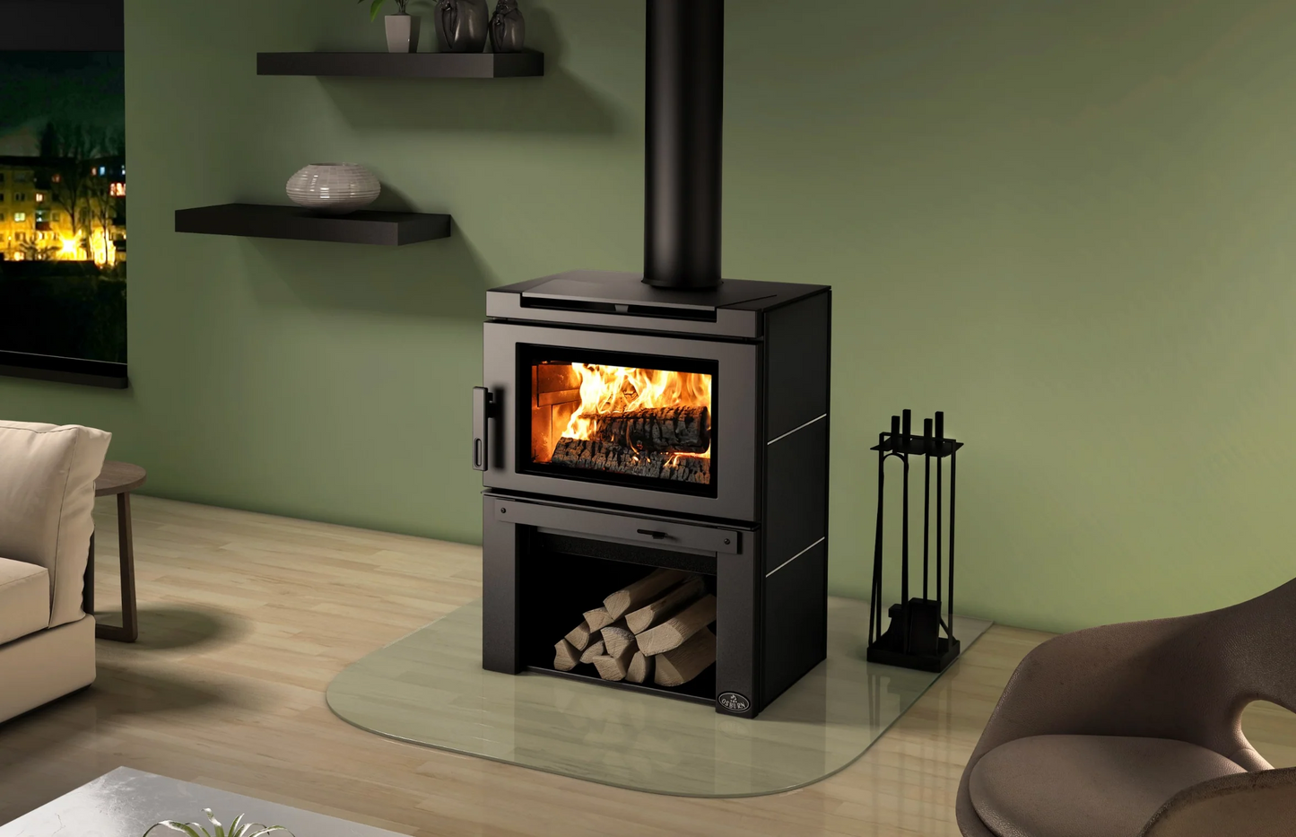 Black Top and Side Panel Osburn Matrix  Wood-burning stove with fire burning inside, logs stacked in the Firebox Underneath the stove, shelves and a green wall.
