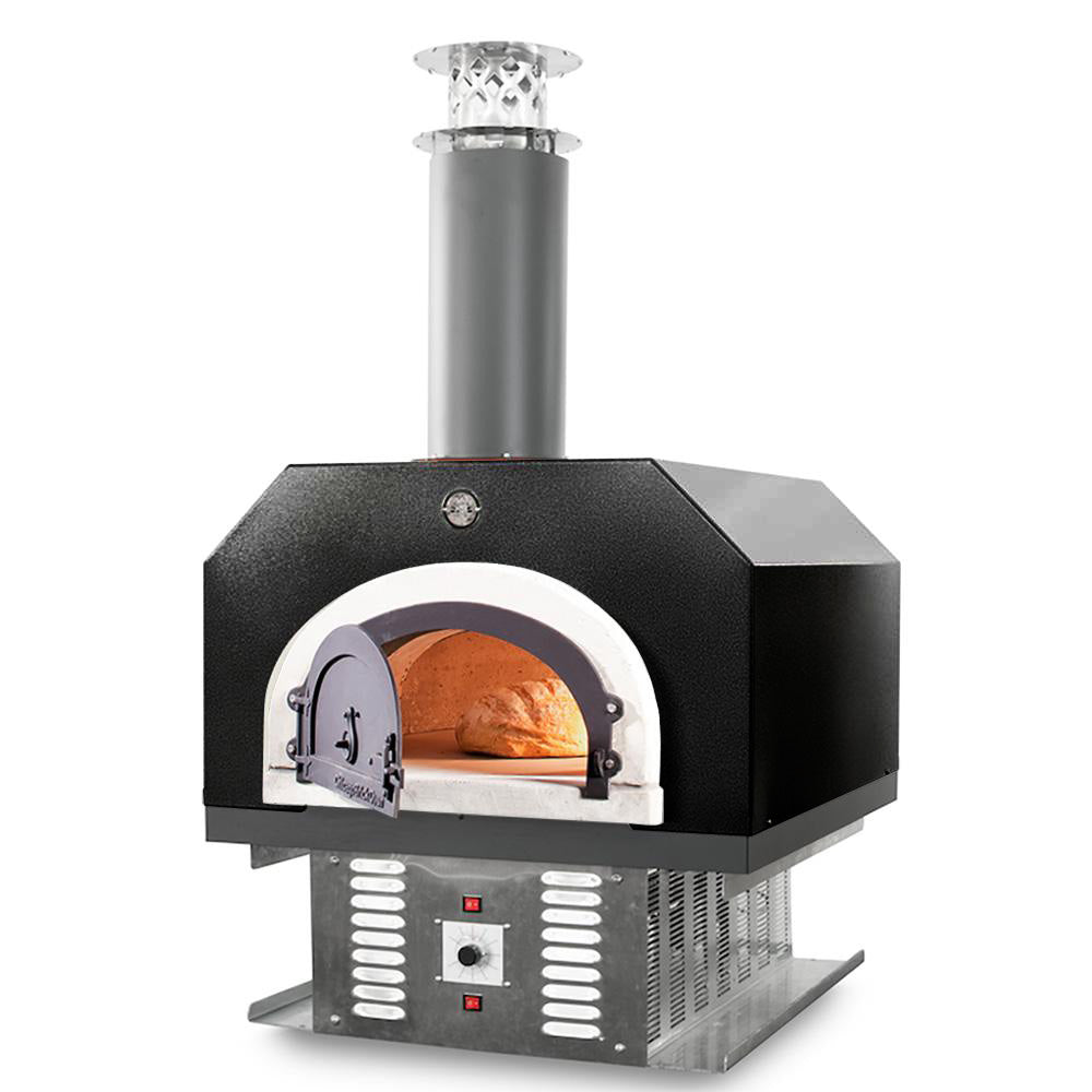 A countertop Chicago Brick Oven 750 Hybrid pizza oven with a visible bread being cooked inside, featuring a silver vein metal exterior and a dark chimney.