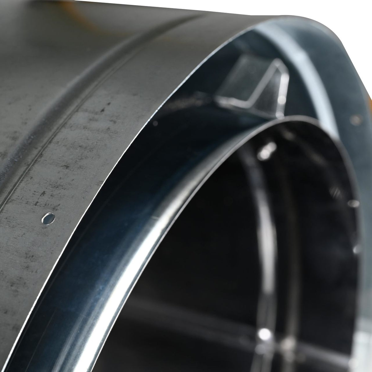 A close-up inner opening view of duratech II chimney pipe showing a circular black metal wall. Exceptional factory-built all-fuel chimney pipe, lightweight design, double-wall, air-cooled chimney system for use with masonry fireplaces which burn wood, oil, coal, or gas.