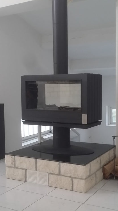 elevated Glass Fireplace with a modern French design. This see through design allows the room to stay open 